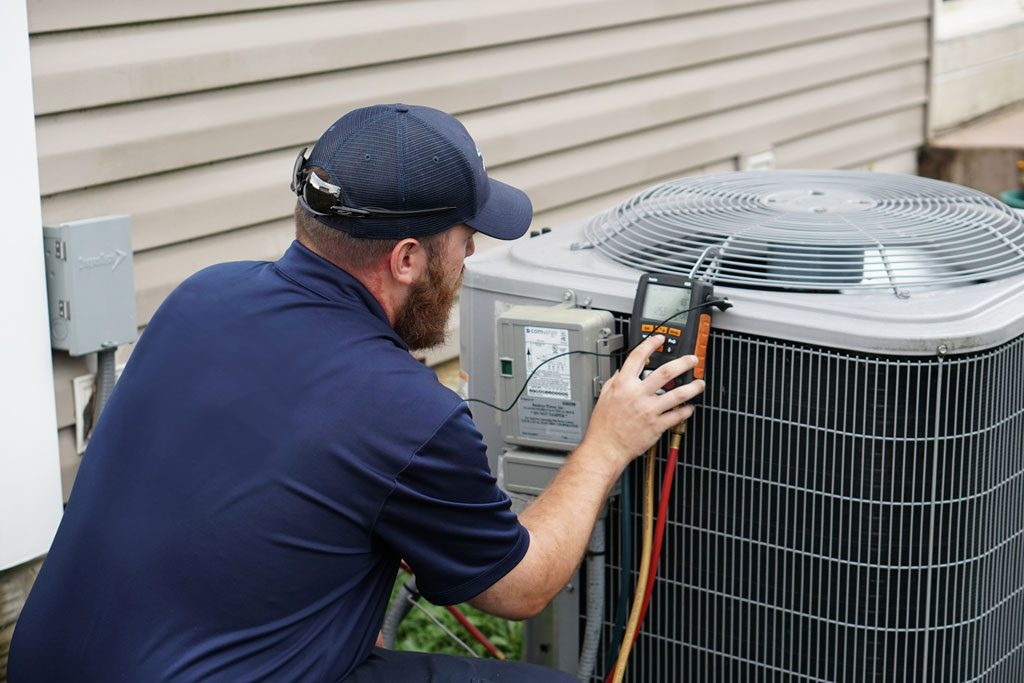 AceComfort technician servicing central heat pump Vancouver